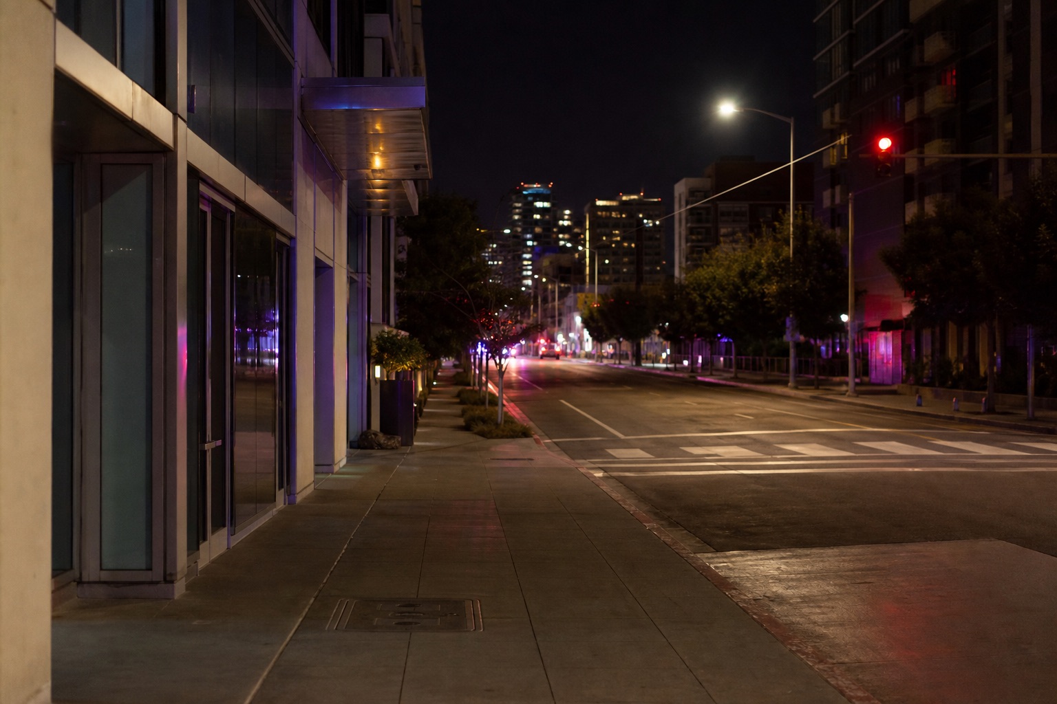 AI editorial reconstruction of an empty downtown San Diego streetscape at night